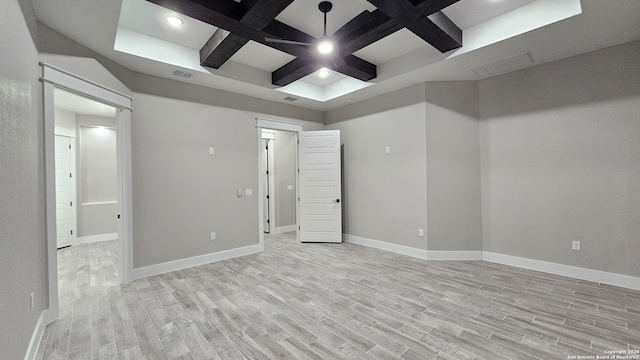 empty room featuring beamed ceiling, light hardwood / wood-style floors, and coffered ceiling