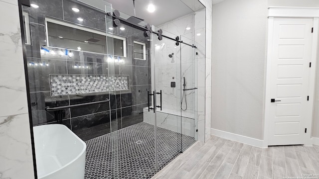 bathroom with hardwood / wood-style floors and independent shower and bath