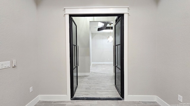 hallway with light hardwood / wood-style flooring