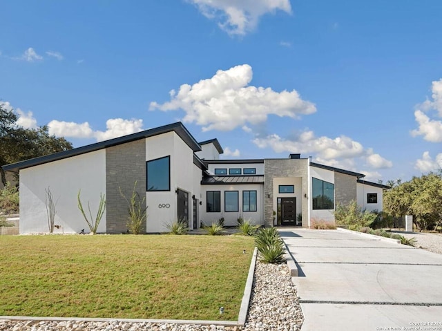 contemporary house featuring a front lawn