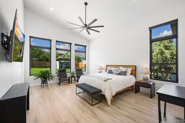 bedroom with high vaulted ceiling, ceiling fan, and light hardwood / wood-style flooring