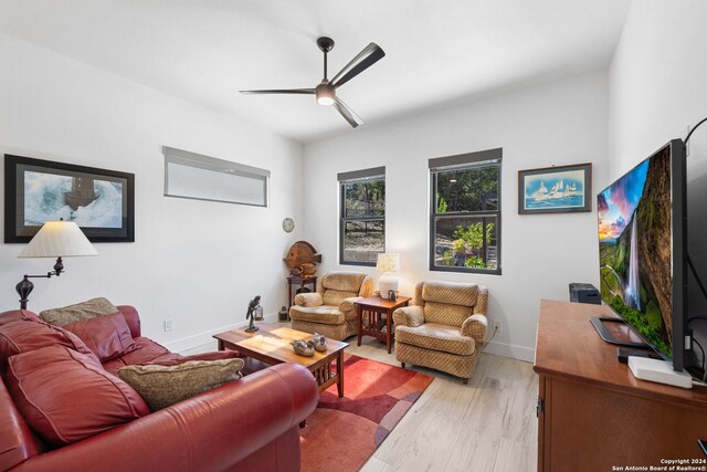 living room with light wood-type flooring and ceiling fan