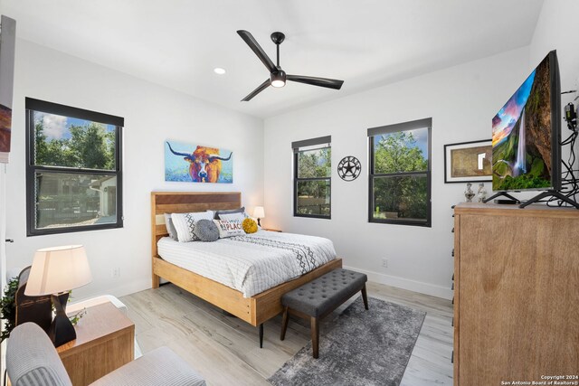 bedroom featuring light wood-type flooring and ceiling fan