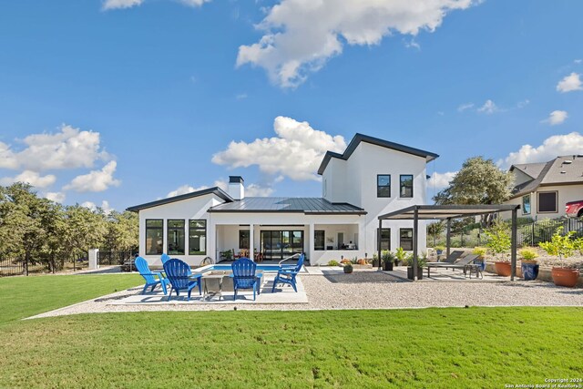 rear view of house featuring a yard and a patio area