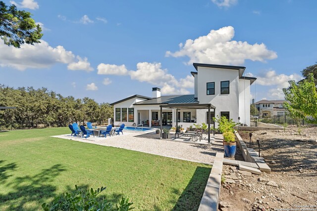 back of house with a lawn and a patio