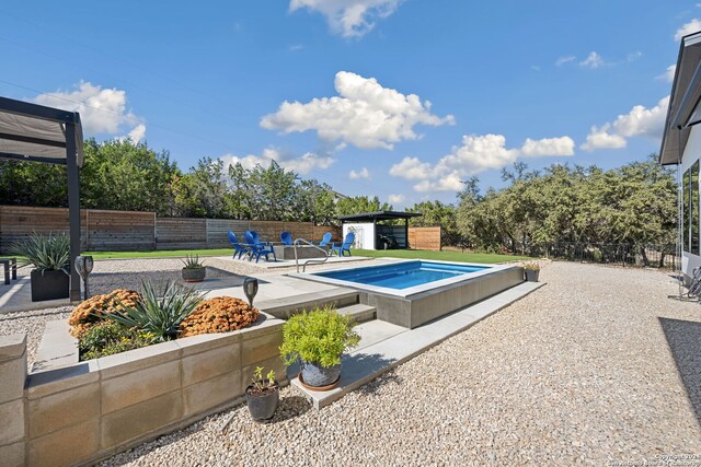 view of pool with an outdoor structure and a patio area