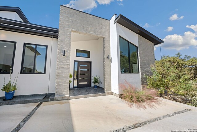 doorway to property with a patio