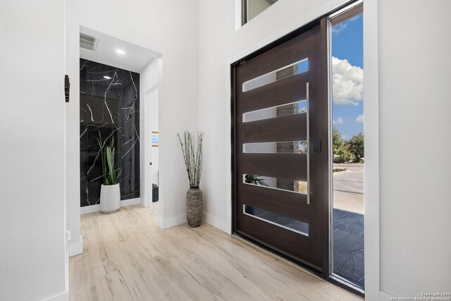 foyer entrance with light wood-type flooring