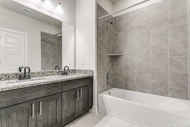 bathroom with vanity and tiled shower / bath