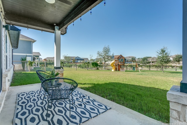 view of yard with a playground and a patio