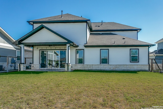 rear view of house with a yard and a patio area