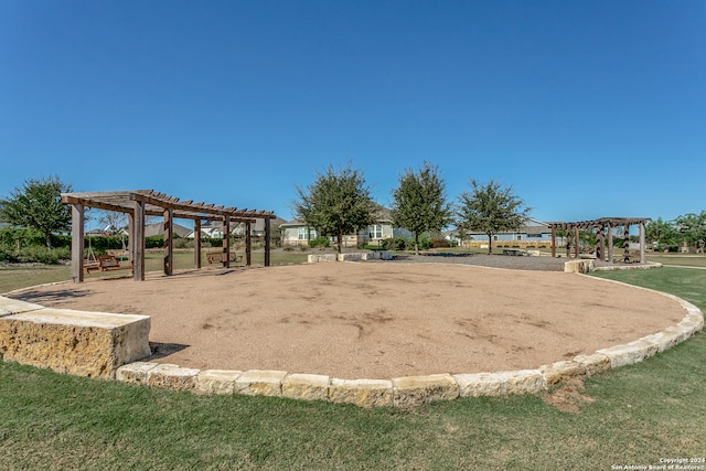 surrounding community with a yard and a pergola