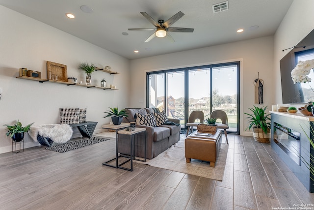 living room with hardwood / wood-style flooring and ceiling fan