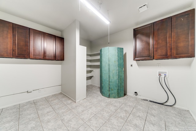 laundry area with washer hookup, cabinets, light tile patterned flooring, and hookup for an electric dryer