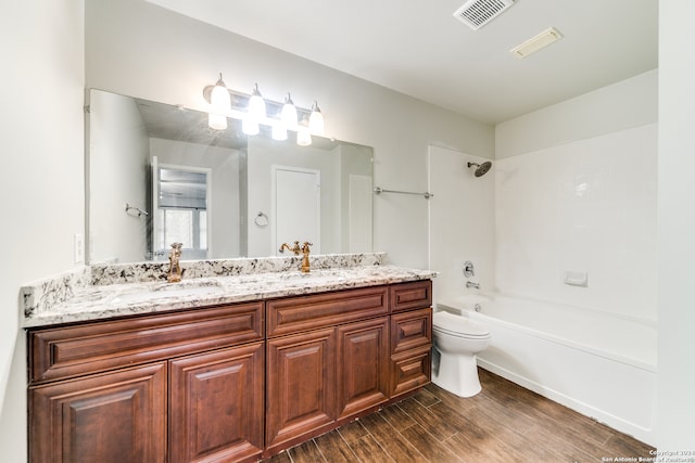 full bathroom featuring wood-type flooring, bathing tub / shower combination, toilet, and vanity