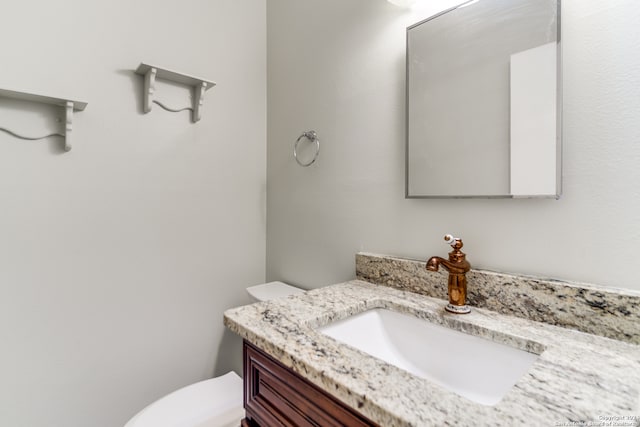 bathroom with toilet and vanity