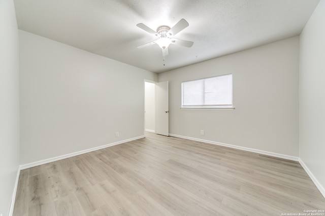 empty room featuring a textured ceiling, ceiling fan, and light hardwood / wood-style flooring