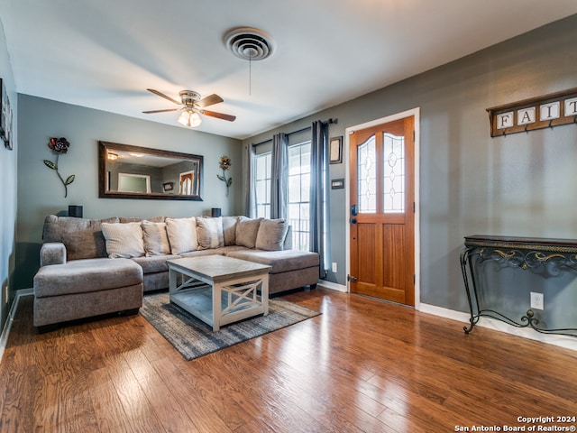 living room featuring hardwood / wood-style flooring and ceiling fan