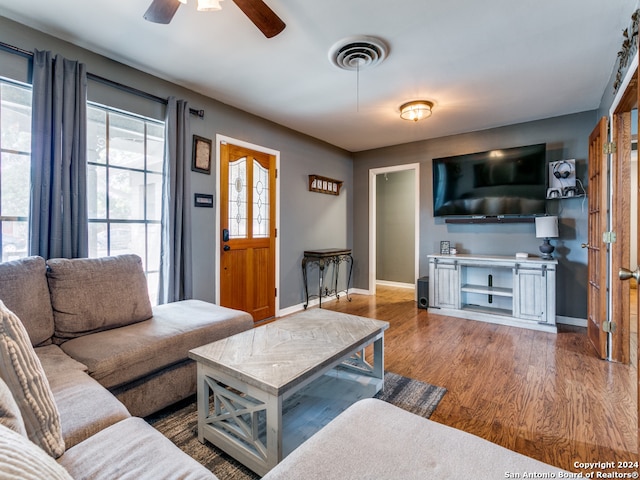 living room with ceiling fan and wood-type flooring