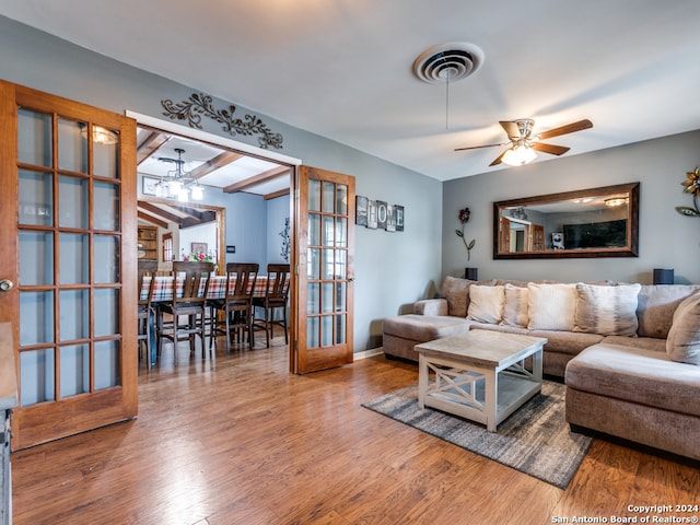 living room with hardwood / wood-style flooring, ceiling fan, and french doors