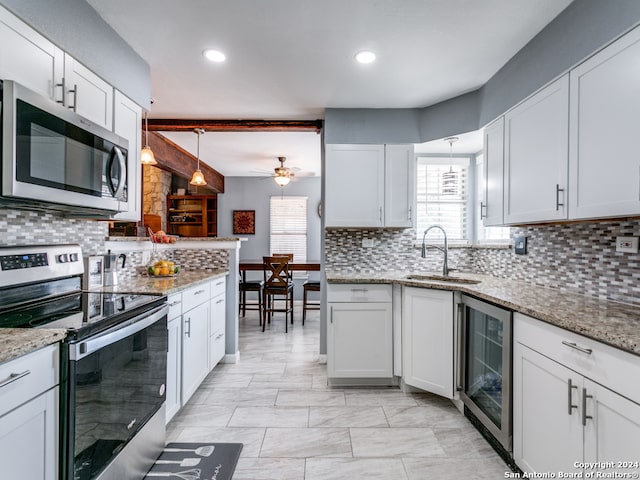 kitchen featuring stainless steel appliances, wine cooler, white cabinetry, decorative backsplash, and ceiling fan