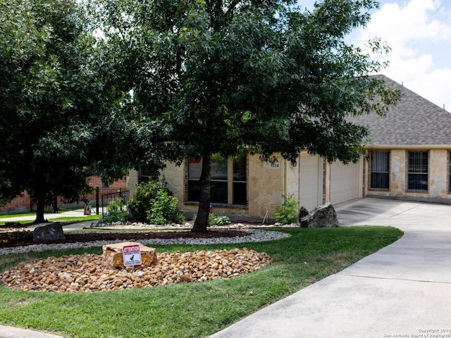 view of front of home with a garage and a front yard