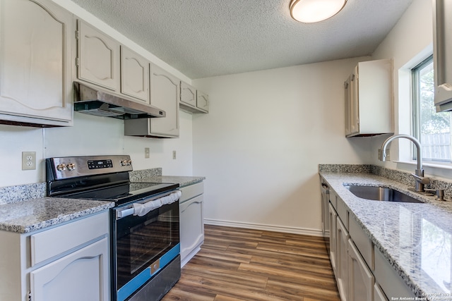 kitchen featuring sink, a textured ceiling, stainless steel range with electric stovetop, white cabinets, and dark hardwood / wood-style flooring