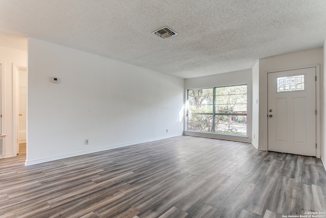 interior space featuring wood-type flooring and a textured ceiling