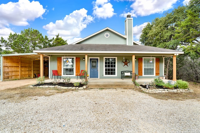 view of front of property with a porch and a carport