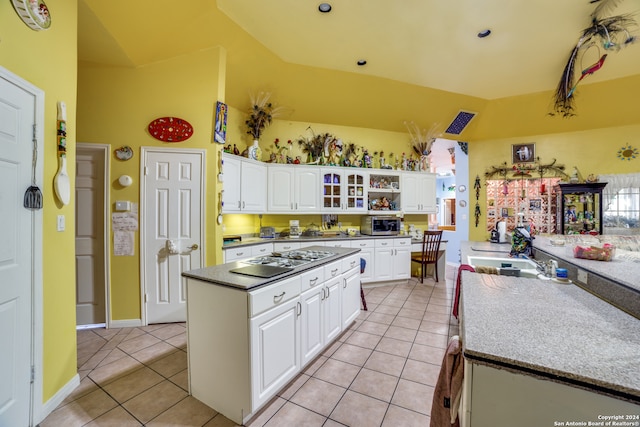 kitchen with white cabinets, light tile patterned floors, and gas stovetop