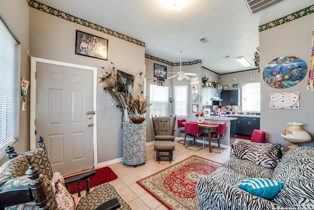 tiled living room with ceiling fan