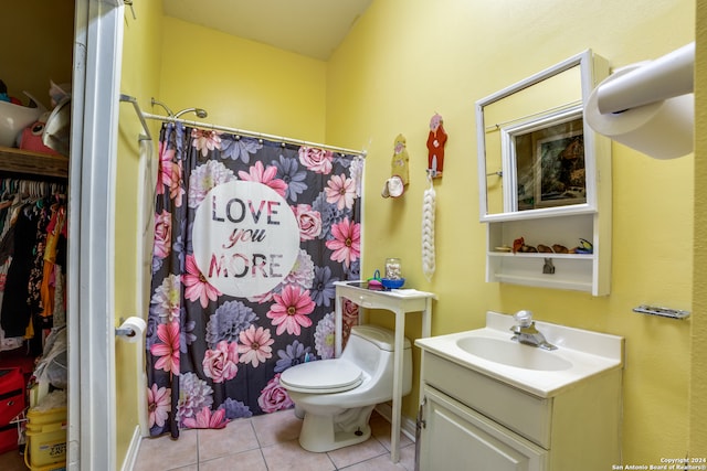 bathroom with toilet, vanity, tile patterned flooring, and a shower with shower curtain