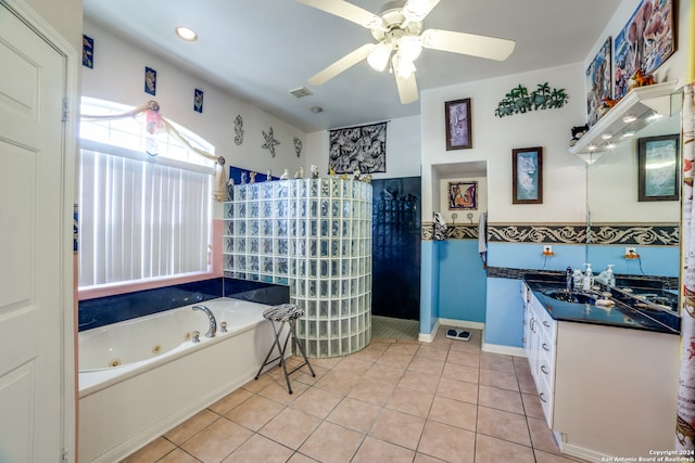 bathroom with ceiling fan, vanity, a bathing tub, and tile patterned flooring