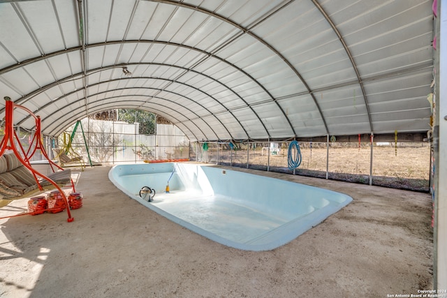 exterior space featuring concrete floors and lofted ceiling