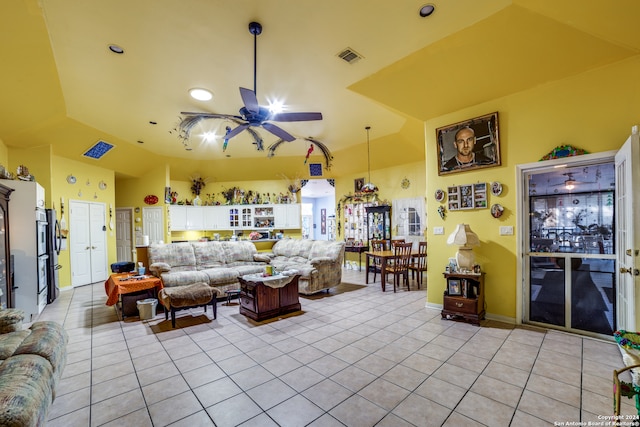 tiled living room with lofted ceiling and ceiling fan