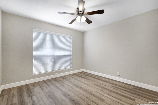 unfurnished room featuring hardwood / wood-style flooring and ceiling fan