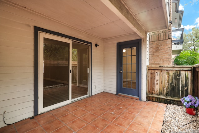 view of exterior entry featuring a patio area