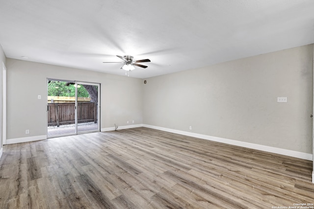 spare room with light wood-type flooring and ceiling fan