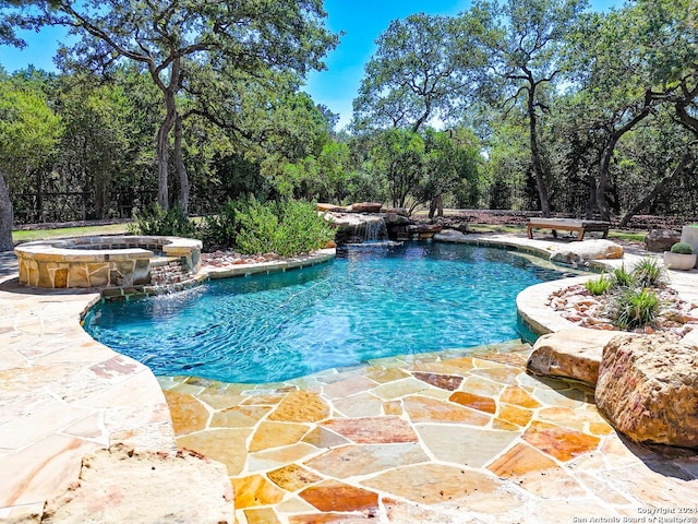 view of swimming pool with an in ground hot tub, pool water feature, and a patio area