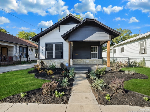 bungalow featuring a front yard and a porch