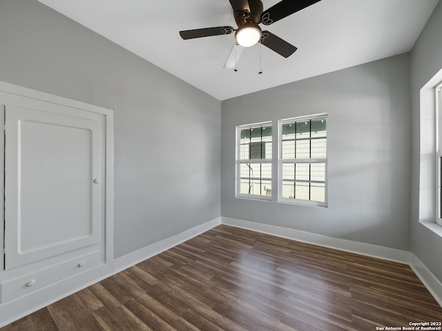 unfurnished room with ceiling fan, lofted ceiling, and dark hardwood / wood-style floors