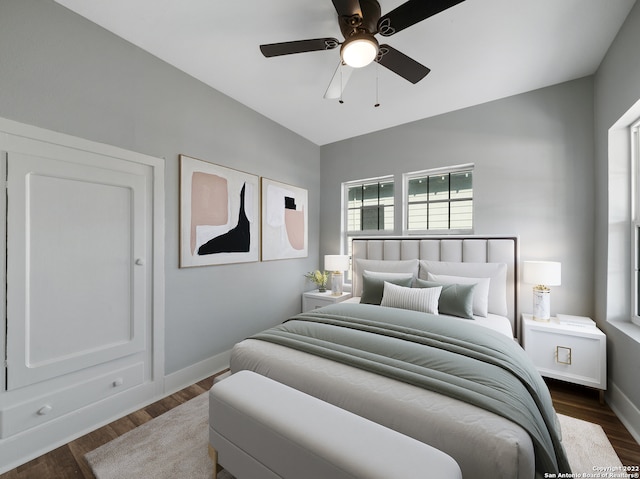 bedroom with vaulted ceiling, ceiling fan, and dark hardwood / wood-style floors