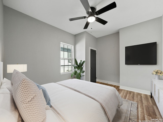 bedroom with wood-type flooring and ceiling fan