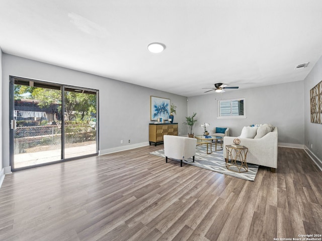 living room with hardwood / wood-style floors and ceiling fan