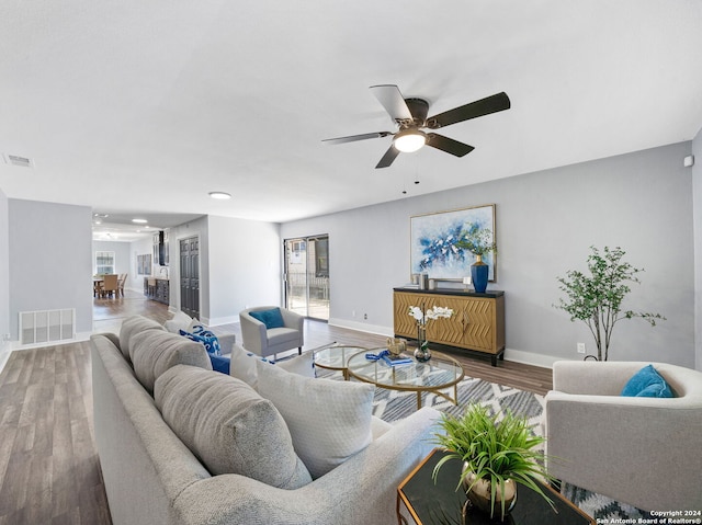 living room with hardwood / wood-style flooring and ceiling fan