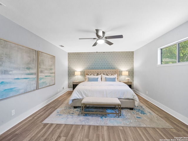 207 Ray Ave, San Antonio, TX 78204 - bedroom with an accent wall, wood finished floors, and ceiling fan