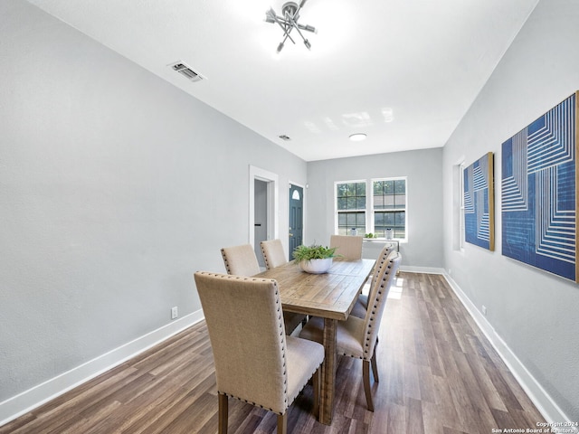 dining space with hardwood / wood-style floors