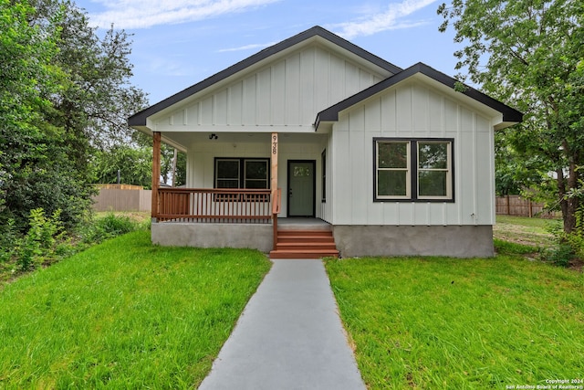 view of front of house with a porch and a front lawn