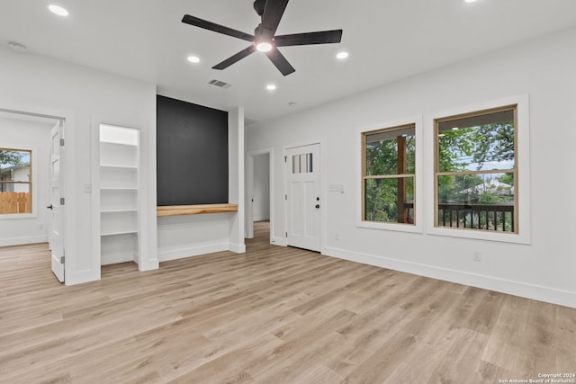 unfurnished living room featuring light wood-type flooring and ceiling fan