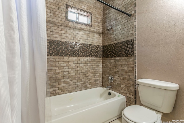 bathroom featuring toilet and shower / bath combination with curtain